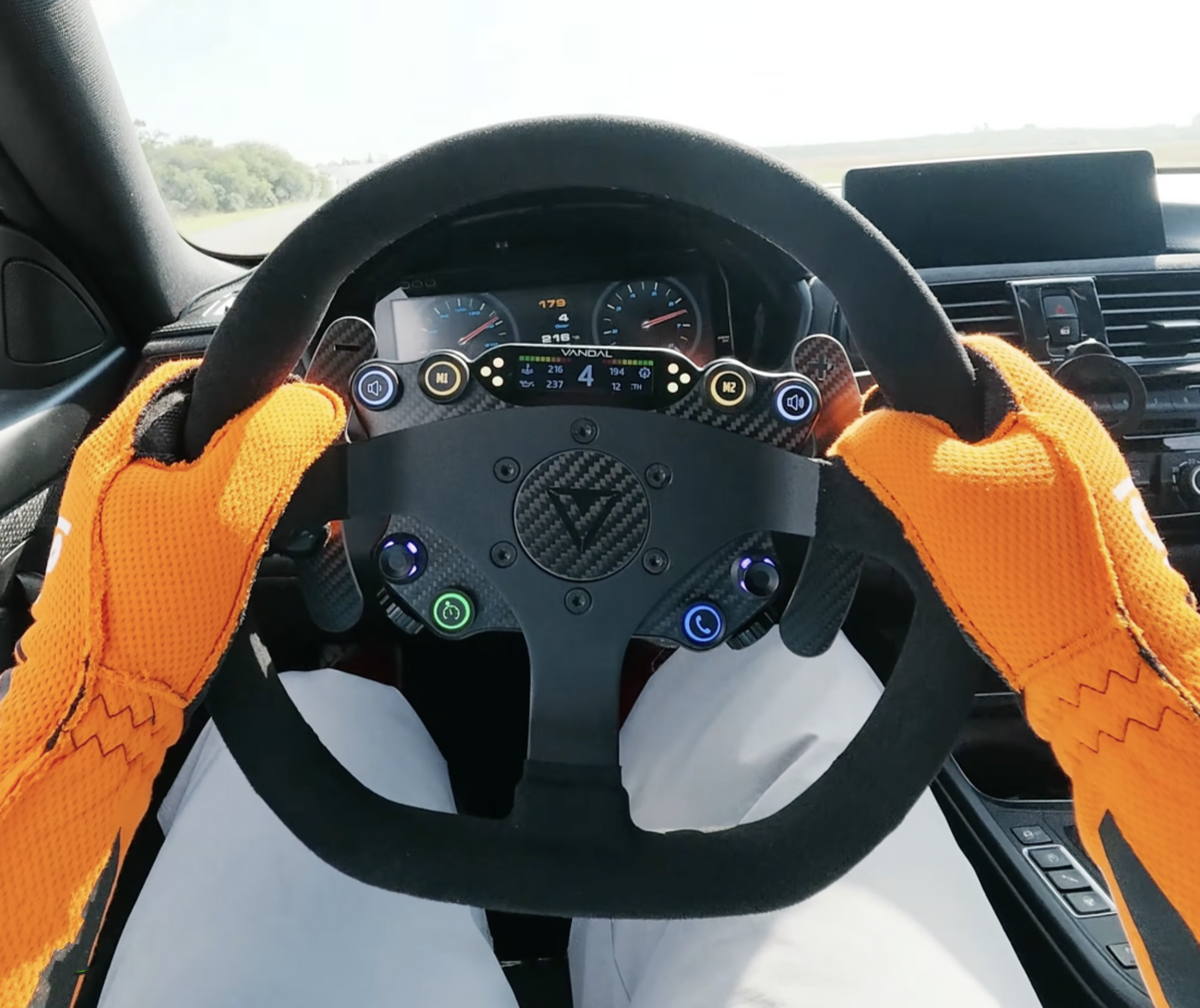 VANDAL DSP steering wheel and driver controls in a race car cockpit